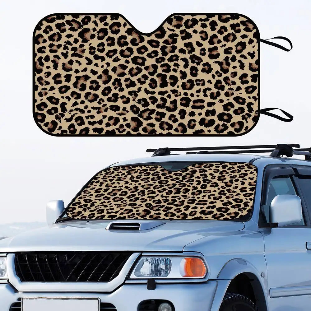 Leopard print car windshield sunshade placed on a white pickup truck.