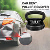 A black car dent puller remover tool with suction cups is shown near a car's taillight.