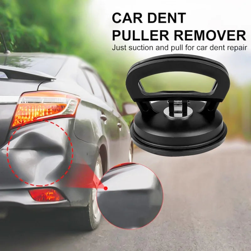 A black car dent puller remover tool with suction cups is shown near a car's taillight.