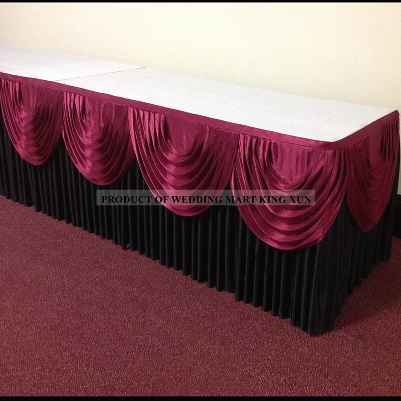Elegant ice silk table skirt in deep magenta with ruffled draping and a matching top swag.