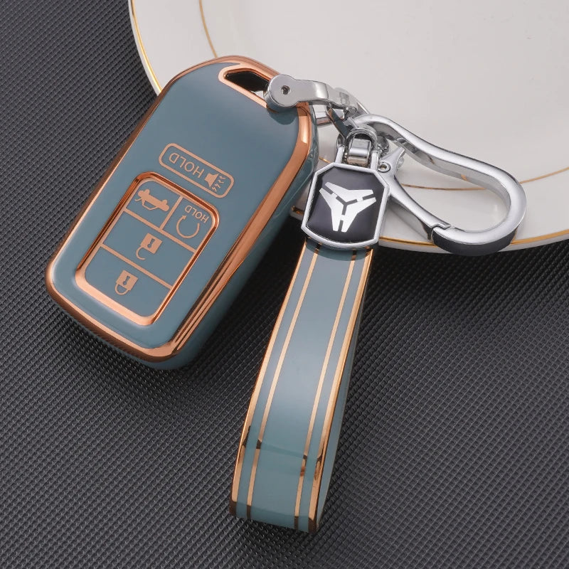 A teal TPU protective key case with a silver clip and leather strap is shown resting on a white plate.