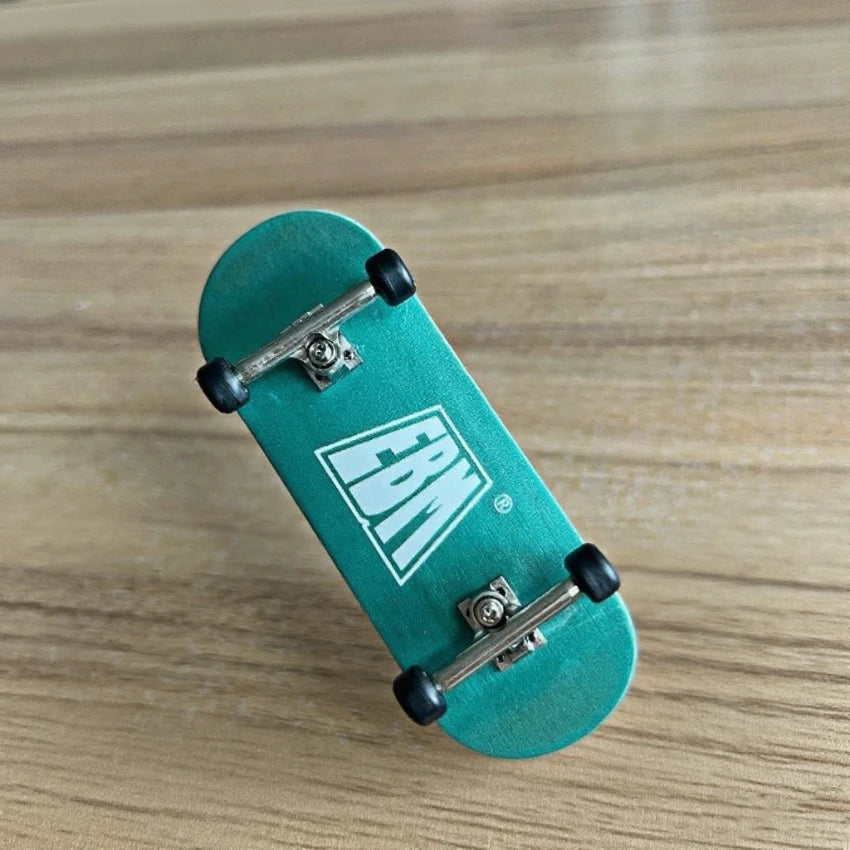 A teal skateboard with wooden fingerboards and realistic trucks resting on a light wood surface.