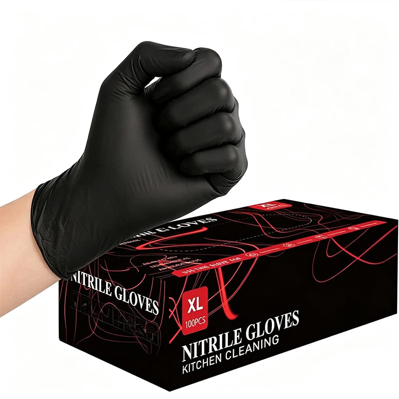 A hand wearing a black disposable nitrile glove is shown holding a box of nitrile gloves for kitchen cleaning.