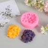 A set of pink and purple 3D floral silicone molds for crafting candles, soap, resin, and plaster.