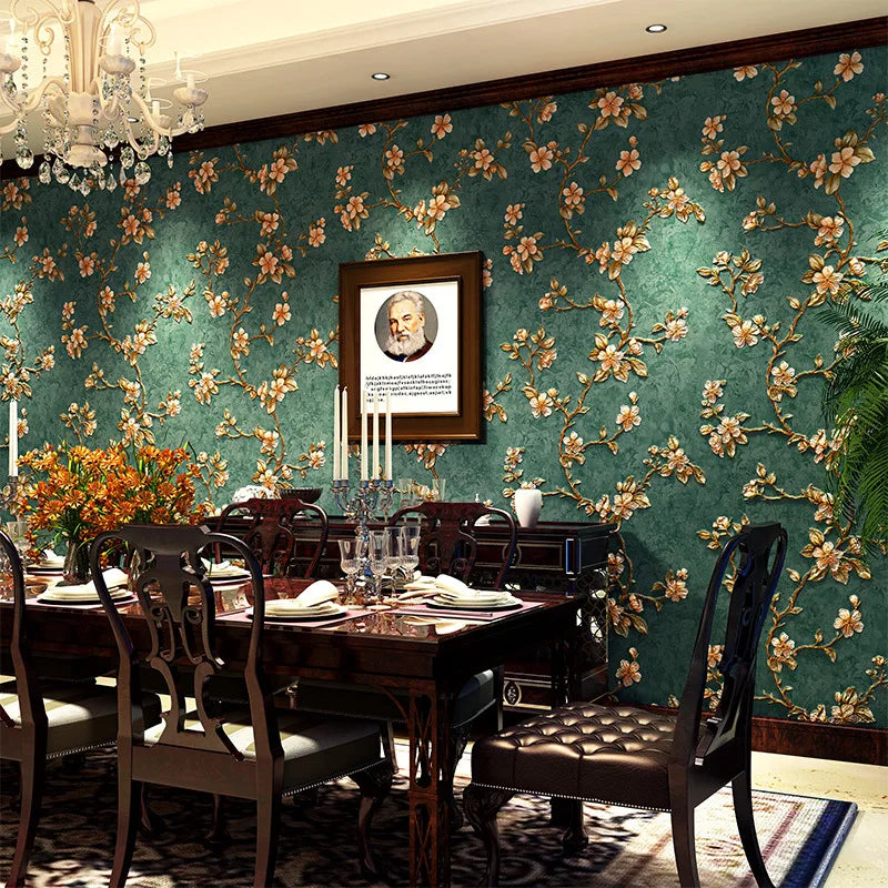 A richly decorated dining room featuring dark wood furniture and a teal floral wallpaper with gold accents.