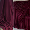 Elegant burgundy stretch jersey fabric draped in luxurious folds for backdrops and decor