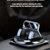 A close-up view of an anti-slip dashboard phone mount with a silver finish resting on a dark surface.