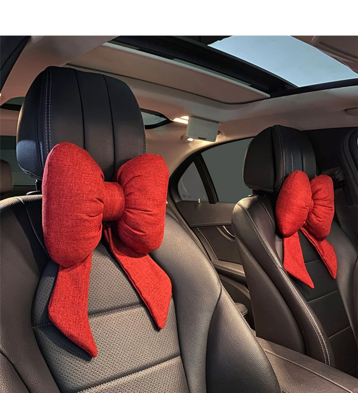 Red butterfly bow tie neck pillow with a textured cover shown in a car interior.