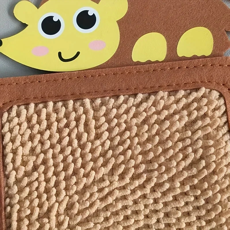 A close-up of a brown felt board with a yellow animal face attached, showing a textured sensory mat.
