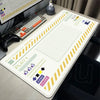 A large Japanese art mouse pad with a non-slip rubber base featuring grid lines and various icons for computer use.