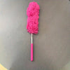 A bright pink flexible microfiber duster with a handle is shown against a gray background.