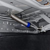 A close-up view of a universal adjustable trunk lift spring kit being installed on a vehicle's interior frame.