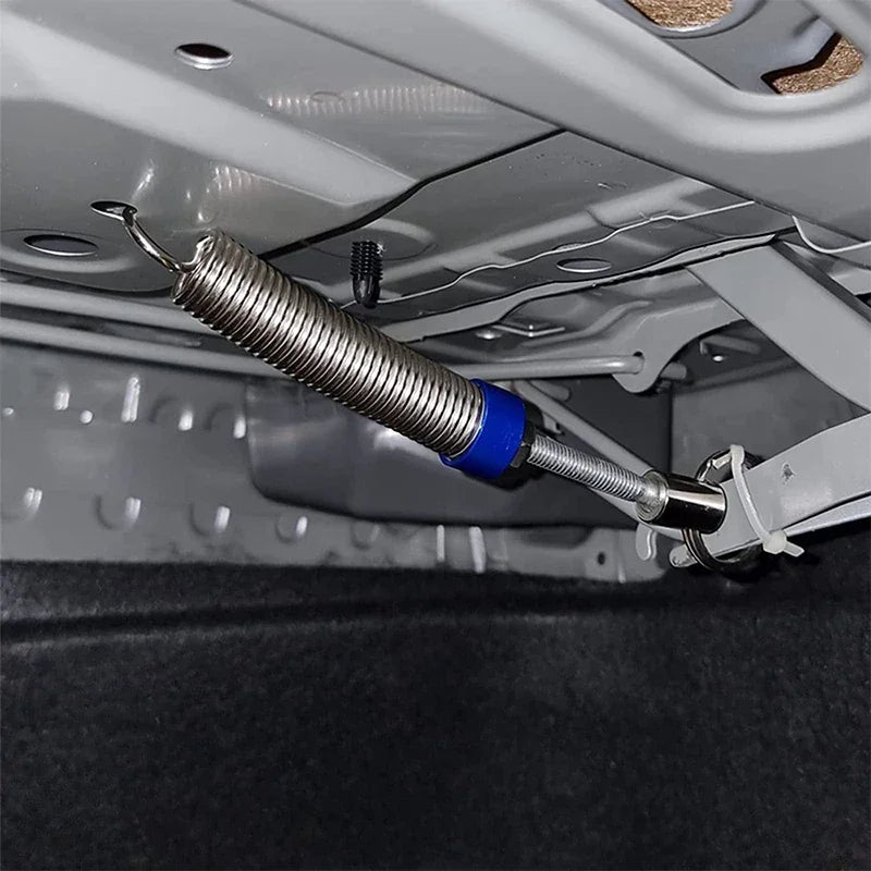 A close-up view of a universal adjustable trunk lift spring kit being installed on a vehicle's interior frame.