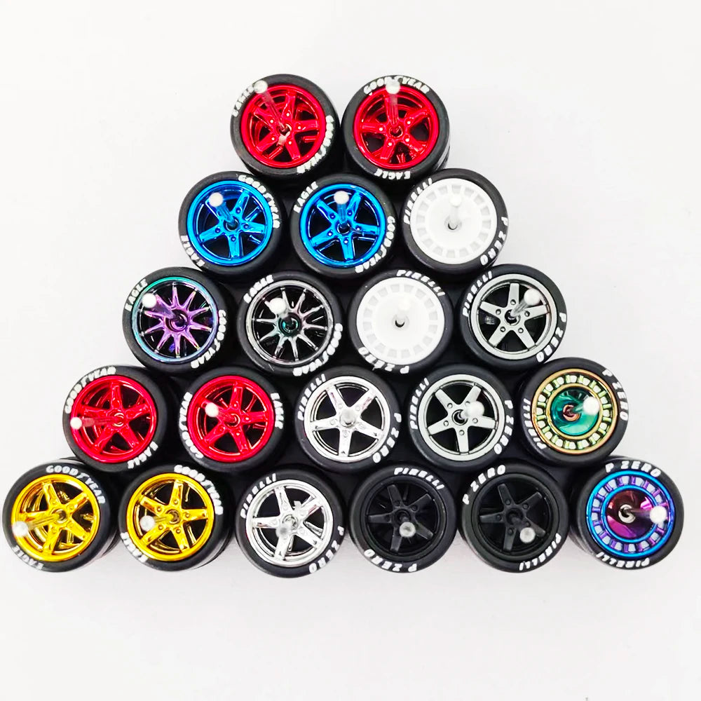 A collection of ten pairs of 1:64 scale alloy car wheels and tires in various colors and finishes.