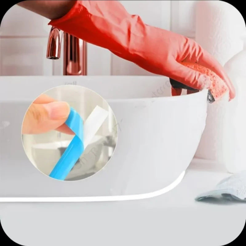 A hand in a red glove is applying blue self-adhesive tile gap tape to a white ceramic bowl.