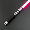 A close-up view of a Neo Pixel lightsaber with a glowing pink blade and black hilt against a dark background.