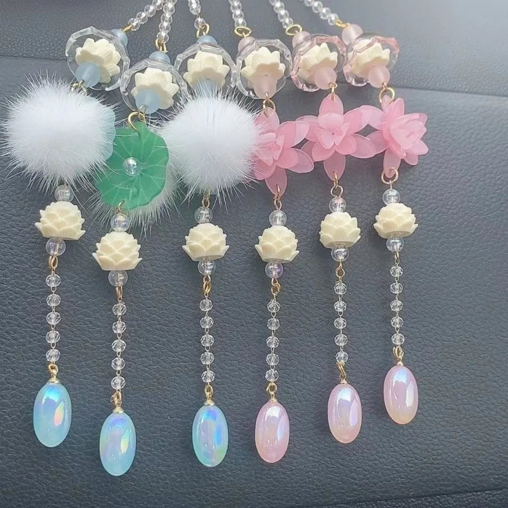 Pink lotus car pendant jewelry featuring white and pink floral charms with iridescent beads