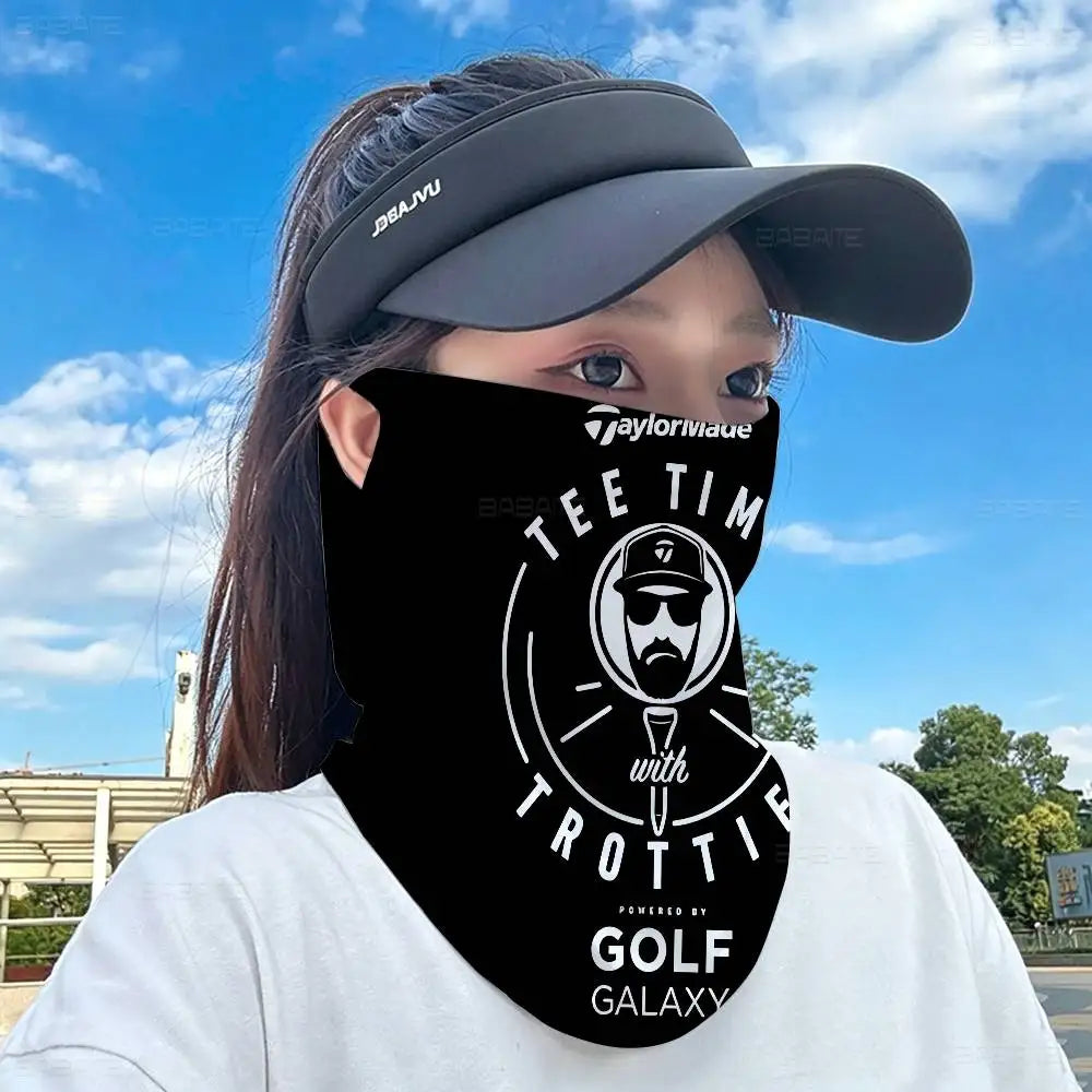 A person wearing a black neck gaiter with the text Taylorliuae and Tee Tim on it against a blue sky background.