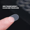 A hand holds a clear, double-sided adhesive patch against a dark background.