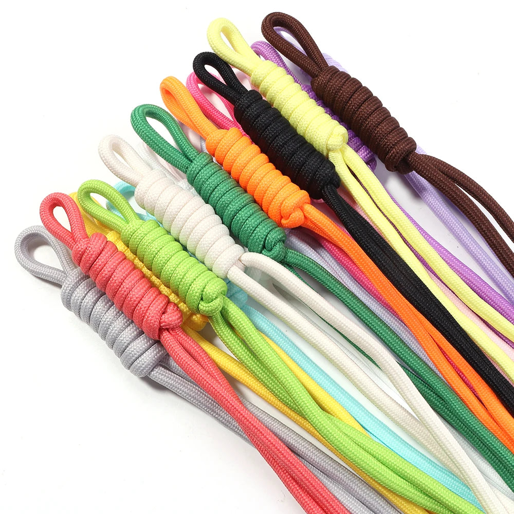 A variety of colorful braided nylon lanyards in shades of yellow, green, orange, purple, and black are displayed.