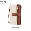 A brown and white leather bifold wallet with a zip-around closure and wristlet strap.