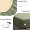 A close-up view of a green linen fitted sheet showing stretchable elastic and a deep pocket feature.
