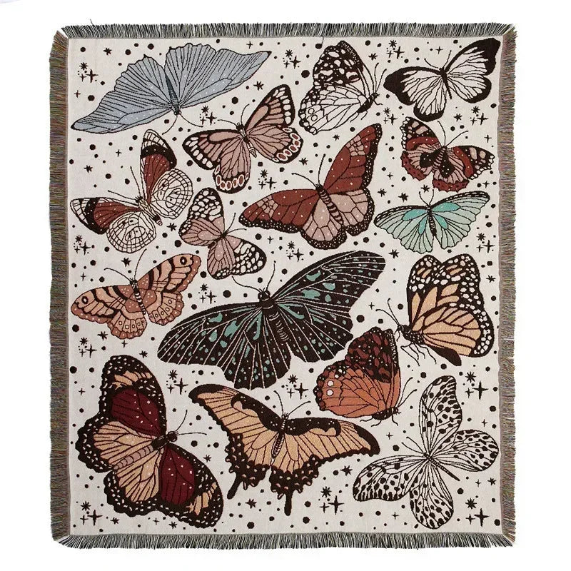 A woven throw blanket featuring a bohemian pattern of various butterflies in earthy tones on a neutral background.