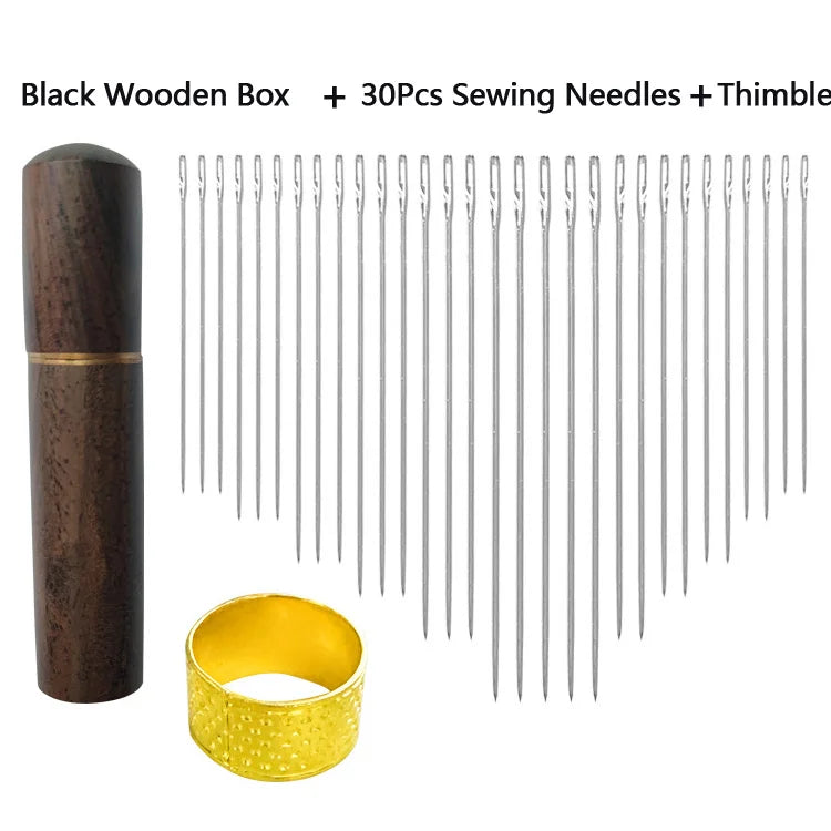 A set of black wooden box, thirty sewing needles, and a gold thimble.