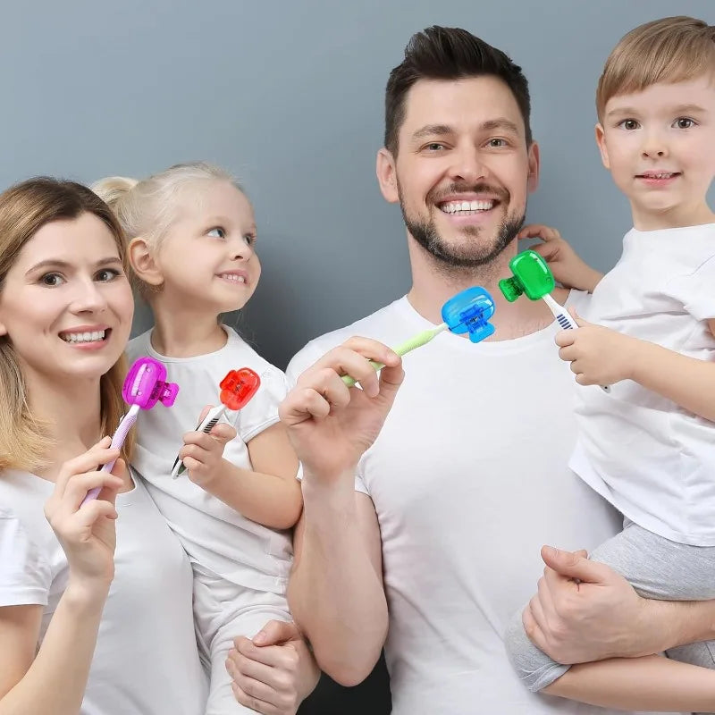 A family of four smiling while holding and demonstrating portable toothbrush head covers with clips.