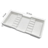 White plastic drawer organizer tray with divided compartments for dental instruments