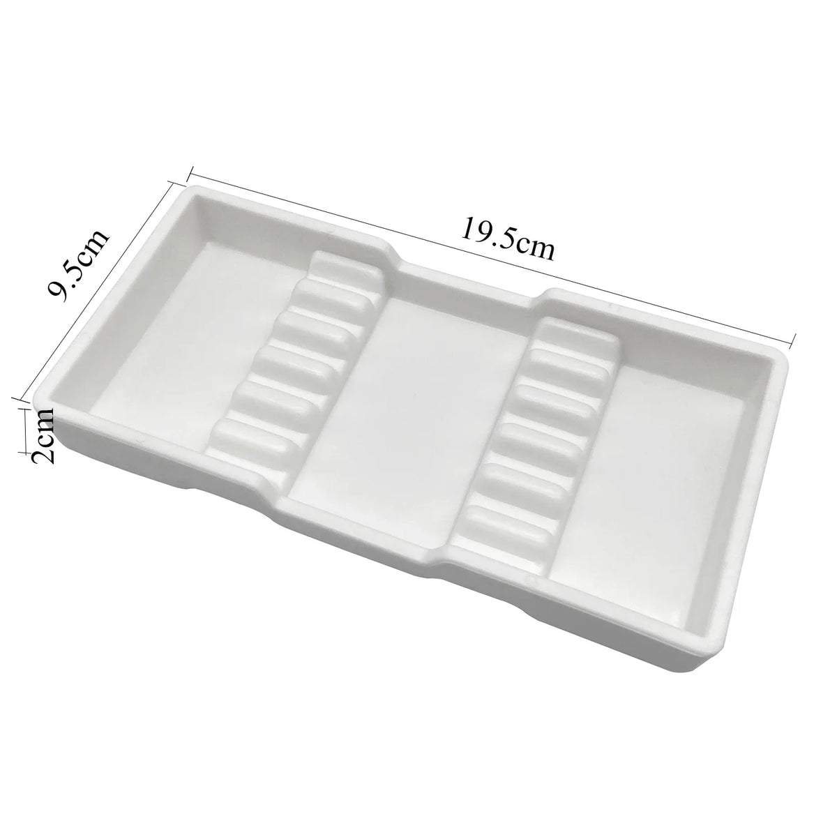 White plastic drawer organizer tray with divided compartments for dental instruments