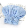 Light blue microfiber hair drying towel with a bow-knot head wrap placed on a wire rack.