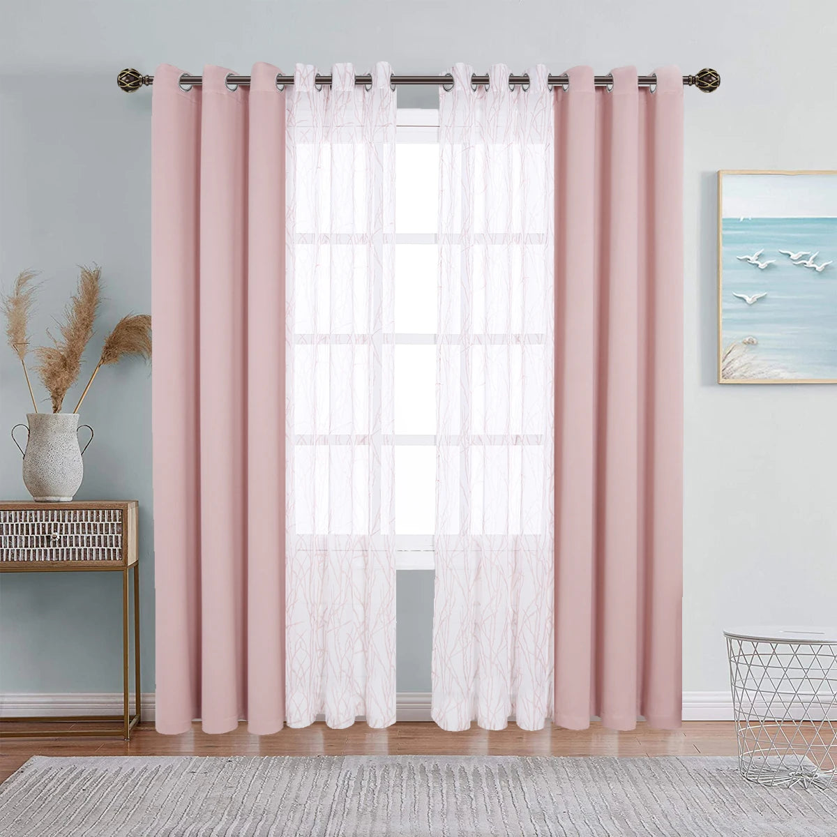Pink dual layer window curtains featuring sheer and blackout fabric hanging on a rod.