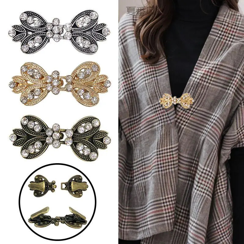 A collection of vintage bowknot rhinestone clothing clips in silver, gold, and bronze tones displayed against a plaid fabric.