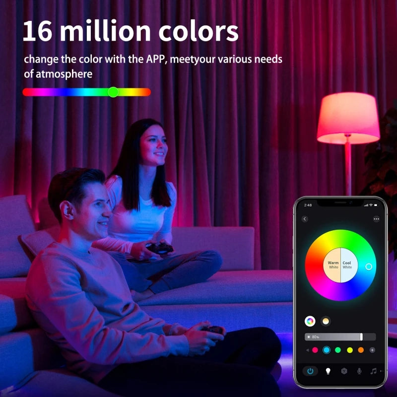 A woman and a man relax on a couch while using an app to change the color of a smart LED bulb.