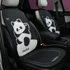 Black car seat covers featuring panda designs and headrest pillows installed in a vehicle interior.