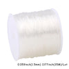 A spool of transparent elastic cord for jewelry making and beading.