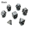 A set of matte black polyhedral dice including a d6, d8, d10, and d20.