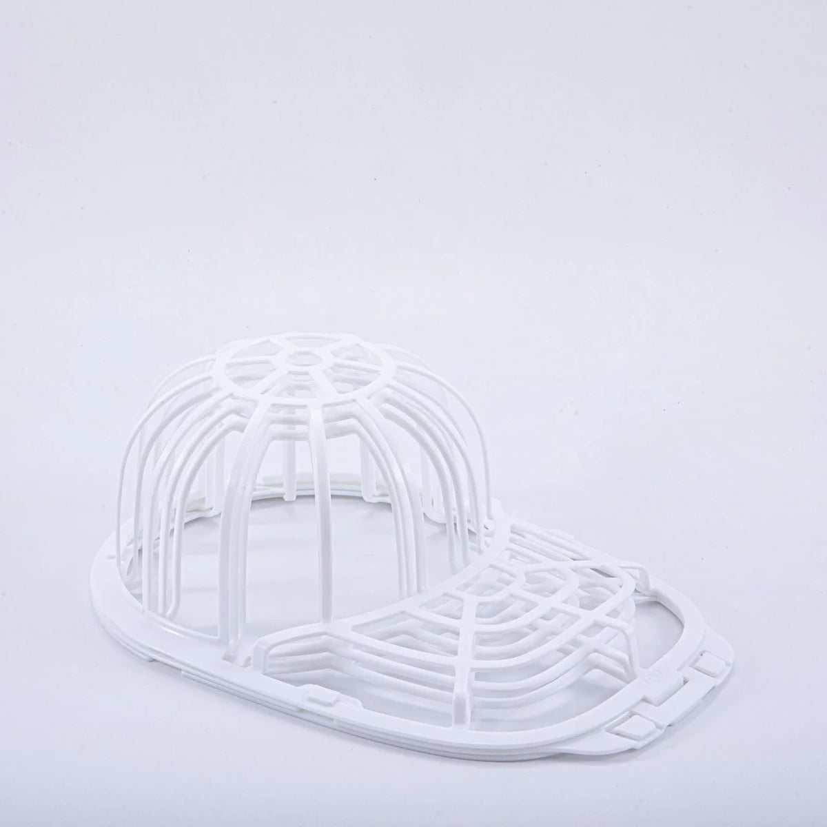 White plastic cap protector cage designed for washing machines.
