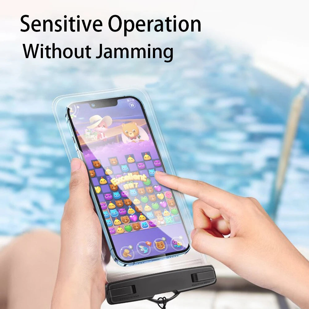 A hand holds a clear waterproof phone pouch with a lanyard, demonstrating a sensitive operation without jamming.