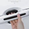 A hand is holding a white car door handle, demonstrating the protective function of car paint stickers.