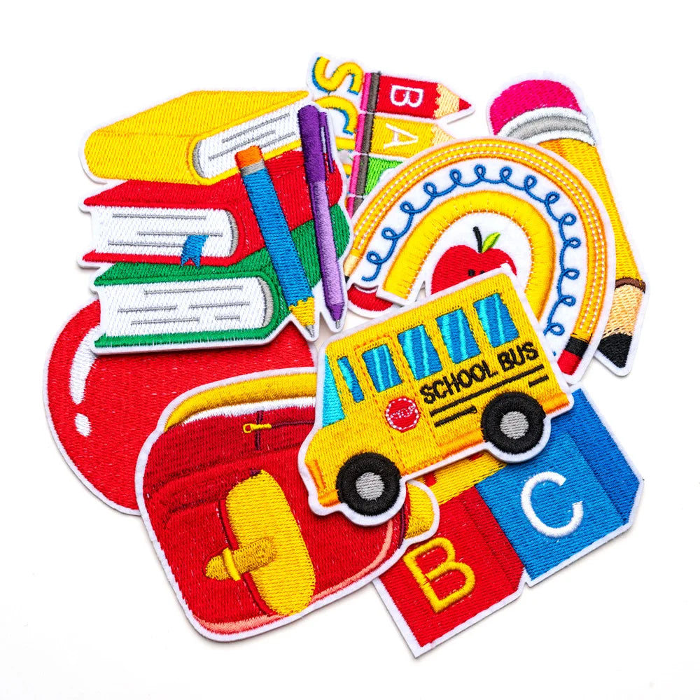 A collection of ten back to school iron-on patches featuring letters, a school bus, and other educational themes.