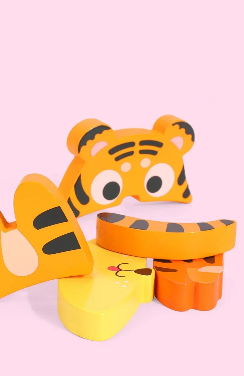 A set of three wooden puzzle pieces shaped like cartoon tigers in orange and yellow colors.