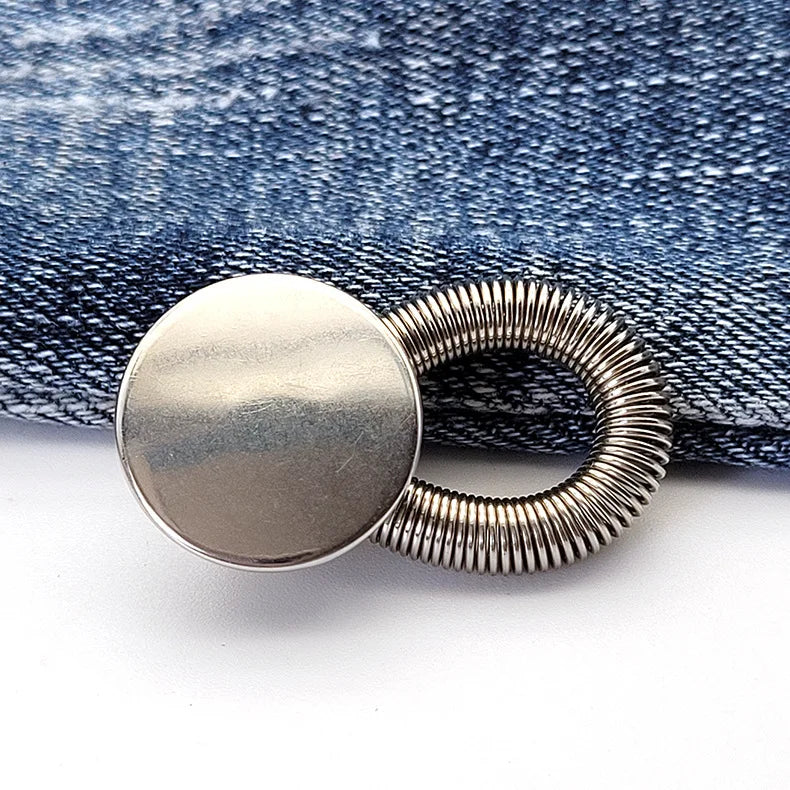 Silver extender buttons attached to a denim fabric background