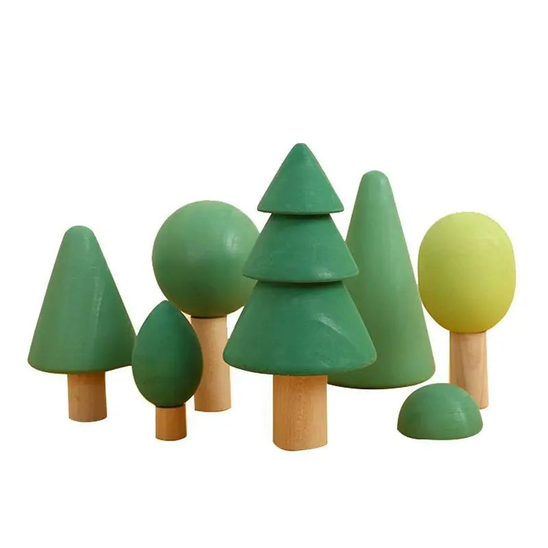 A set of wooden rainbow stacking blocks shaped like trees in various shades of green and yellow.