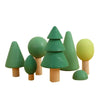 A set of wooden rainbow stacking blocks shaped like trees in various shades of green and yellow.