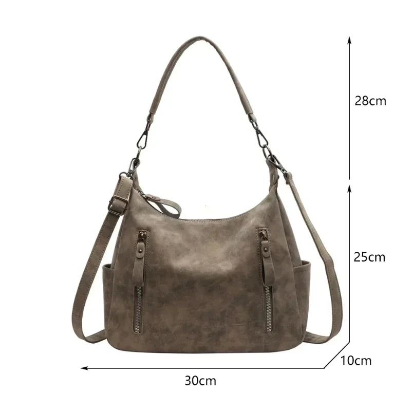 A vintage matte leather crossbody hobo bag in a taupe color shown with dimensions.