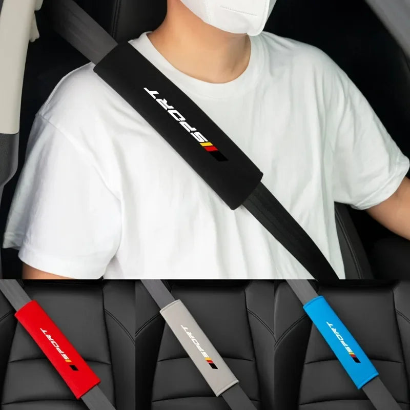 A person wearing a white t-shirt is shown with a black and red soft car seat belt cushion set, featuring various colored belt