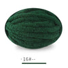 A ball of dark green extra thick chenille yarn for hand knitting projects.
