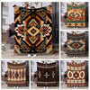 A collection of various ethnic print flannel throw blankets featuring geometric patterns in earthy tones.